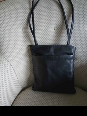 black soft leather bag by Derek Alexander features a signature sewn-in leat